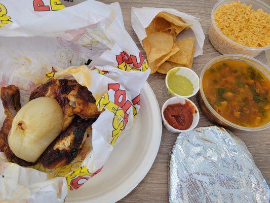 half chicken with rice, beans and flour tortillas.