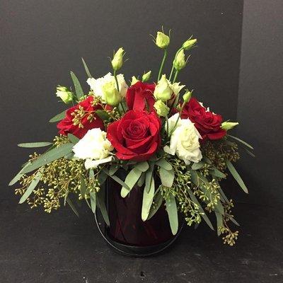 Lantern vase with seeded eucalyptus, roses and lisianthus