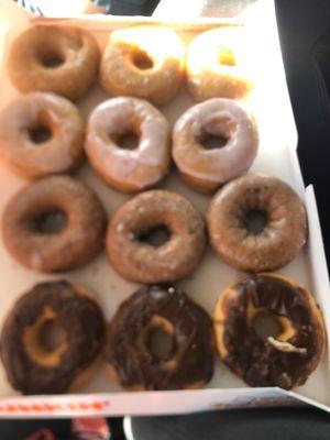 Chocolate frosted donuts, blueberry donuts, strawberry frosted donuts, and glazed.