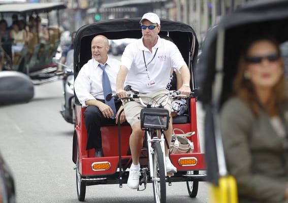 NOLA Pedicabs Owner Vince Marcello shows New Orleans Mayor Mitch Landrieu the sights in a flame red NOLA Pedicab.