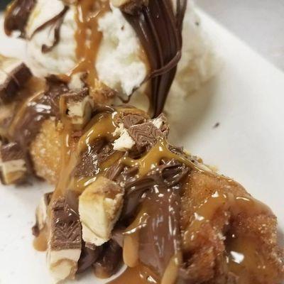 Caramel topped with nutella, Ice Cream, and Snickers.