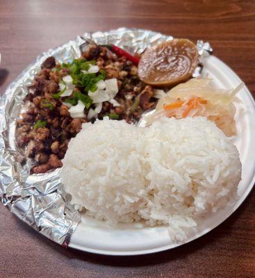 Sisig with atchara (pickled unripe papaya), rice, puto kutsinta (steamed rice cake)