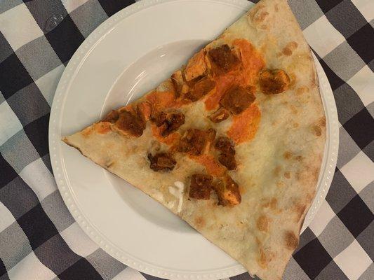 Pizza bread with a few pieces of chicken and a tiny bit of Buffalo sauce