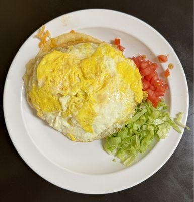 The chicken enchilada special with 2 eggs on top.