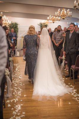 Down the aisle, she did rose petals, and tied baby's breath & tulle to some of the chairs