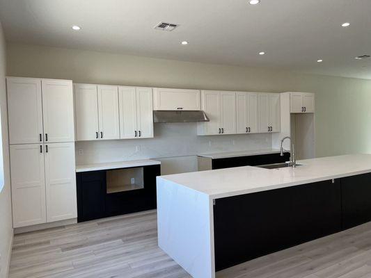 Our White and Mocha cabinets used in this kitchen. Special cabinets were included such as bottom microwave cabinet, spice rack, and more!