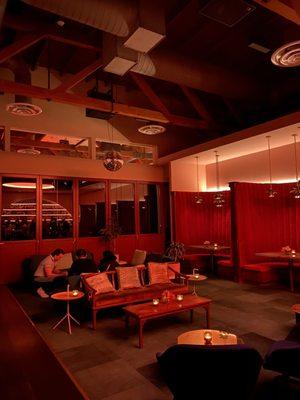 The lounge area and red velvet booths