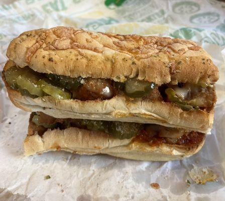 Meatball Sub with EXTRA everything, meatballs, pickles, provolone and parmesan on Italian herbs and cheese bread.