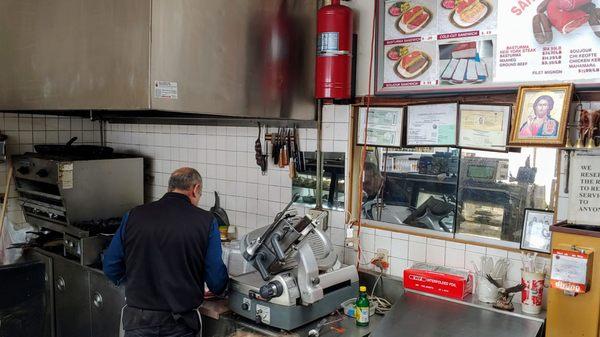 The owner making my Basturama sandwich.