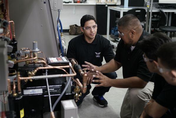 HVAC instructor demonstrating to students in lab.