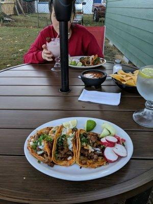 Eating street tacos outside.