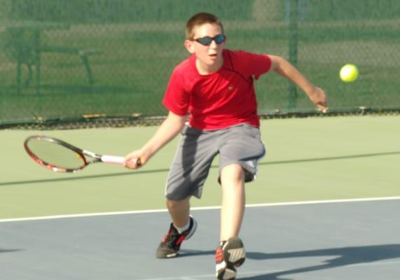 Logan tracks down a low forehand.