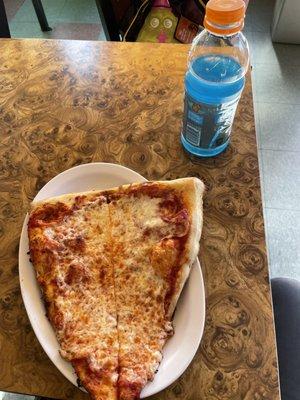 Pizza slices and blue gatorade on table