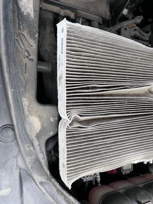 Filter was crushed and reinstalled incorrectly.  You cannot remove it from the engine compartment without doing this!