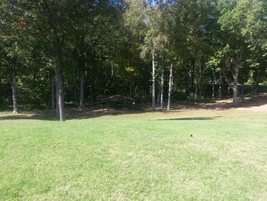 Large grassy area to run around in, more covered picnic tables and grills.  Good for family events.