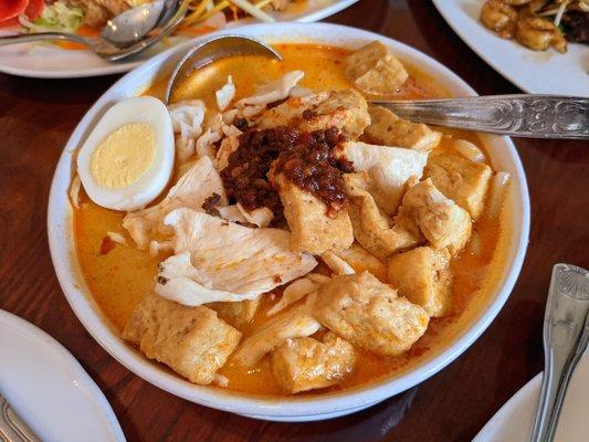 Laksa with chicken. Udon noodles, tofu, bean sprouts, and egg in coconut-spiced soup. $14.95.