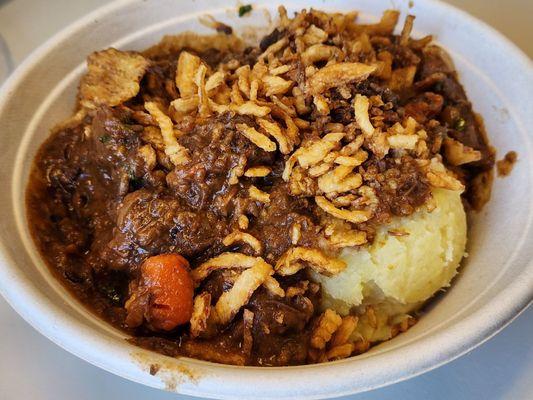 Delicious Beef Bourguignon over mashed potatoes and topped with crispy onions!