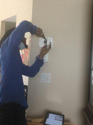 Technician checking thermostat