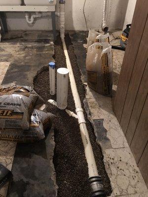 New underground building drain, with floor drain/backwater valve and laundry tray connection.