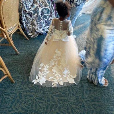 2 yr old wearing altered dress with arrangement of floral cutouts from brides dress lace fabric.