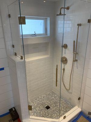 Shower ultra clear glass with satin gold hardware. Laguna Beach CA. Local Glass & Screen company.