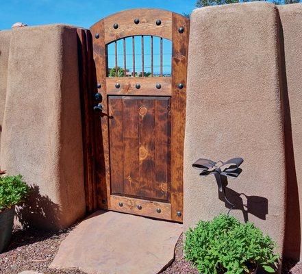 Pine entry gate with copper rod window and calvos.