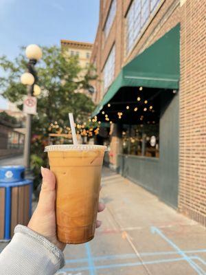 Cold press coffee with caramel in front of the building