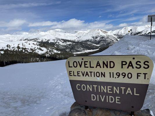 Loveland Pass sign and mountains beyond it