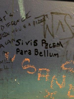 bathroom wall. "Si vis pacem, para Bellum" means if you want peace, expect war in order to get there."