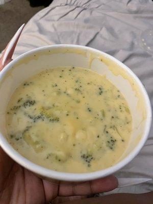 A cups portion of broccoli cheddar soup in a bowl!