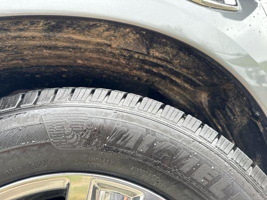 Beach sand remains in wheel wells. No undercarriage wash.