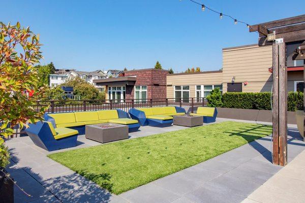 Rooftop Terrace sitting area with grass and fire pits.