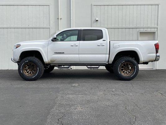 2021 Tacoma SR5 2WD, 4" spindle lift, OME Struts, OME 2" Suspension, 285/70R17 BFG KO2 with white wall, 17" Fuels-Matte Bronze Vectors.