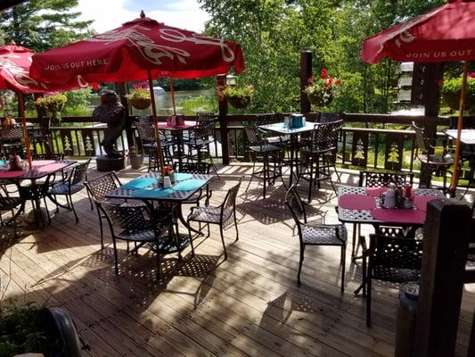 Beautiful outdoor dining area overlooking perennial gardens and Lower Buckatabon Lake.