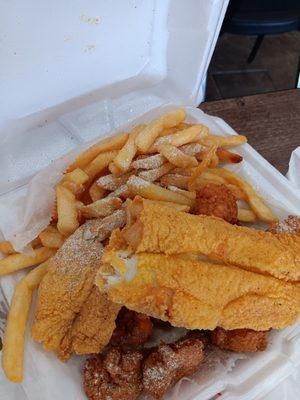 Fried catfish fillet, fried  french fries  and white bread  .