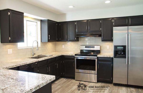 We kept the cabinets in this space, and just updated some small features: granite, backsplash, stained cabinets, lighting, and new sink.