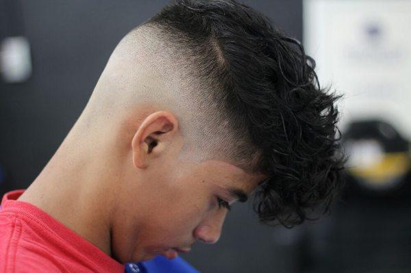 Bald fade with styled hair on top ..