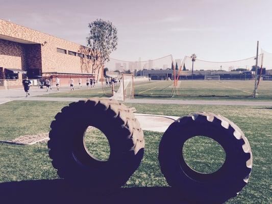 Tire flips on the football field.