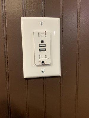 Charging outlets installed at all the tables along each outside wall.