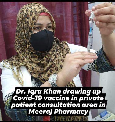 Dr. Iqra Khan, supervising Pharmacist, drawing up Covid-19 vaccine in private consultation area for clients.