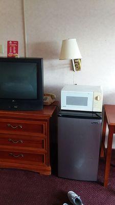 Classic tv and microwave, crooked lamp