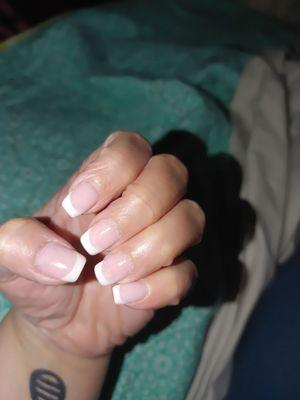 Manicure with French white tips and pink base color called bubble gum