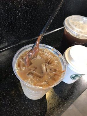 Iced caramel macchiato, with straw showing the frozen-like caramel sticking to it like glue and not blending with my drink.