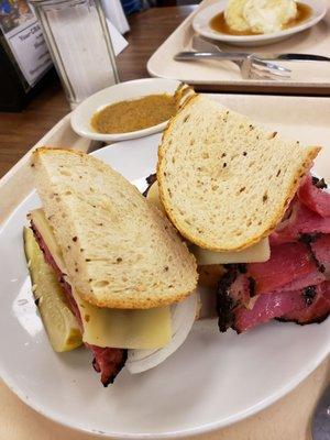 The Pastrami on Rye with swiss cheese, onion and spicy mustard