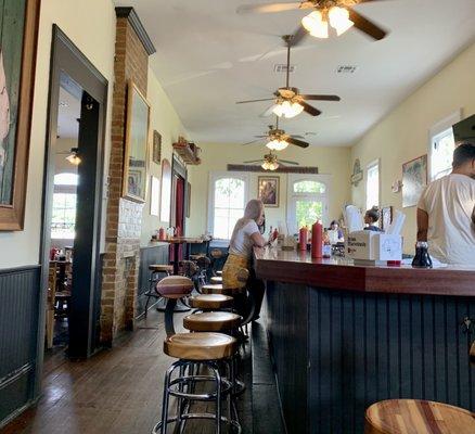 Upstairs is bright and sunny. Seating at the bar is available.