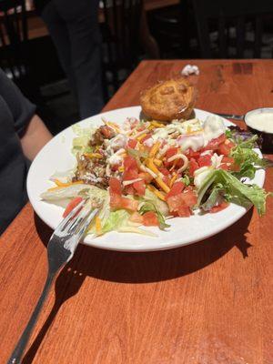 Vegan style salad with beans and rice and cornbread.