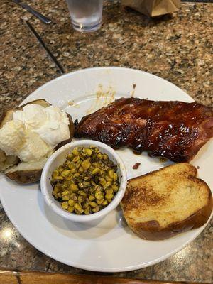 I/2 rack of ribs and two sides, corn and baked potato