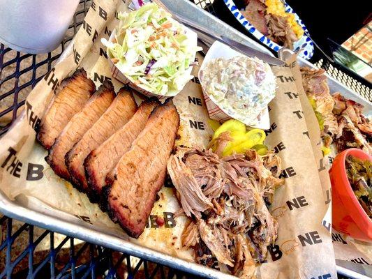 Sliced brisket, pulled pork, slaw, potato salad