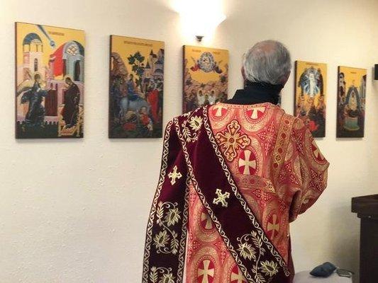 Deacon walking aeound the church, censing the icons