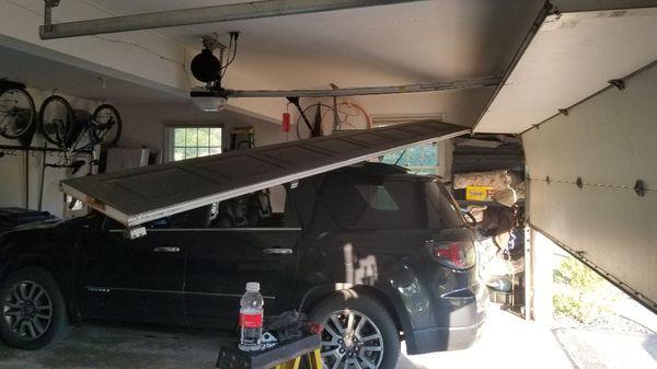 Garage door hanging over a car